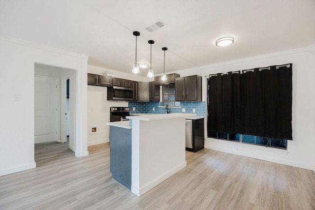 kitchen with stainless steel appliances, light countertops, hanging light fixtures, visible vents, and a kitchen island