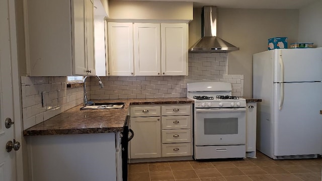 3304 Avon Dr, Denton, TX 76209 - kitchen with white appliances, wall chimney exhaust hood, dark countertops, a sink, and white cabinets