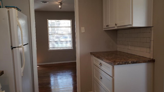 3304 Avon Dr, Denton, TX 76209 - kitchen with freestanding refrigerator, white cabinets, wood finished floors, backsplash, and baseboards