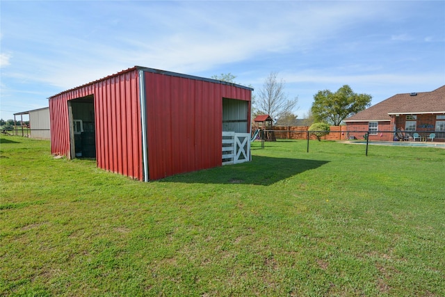 view of pole building with a yard and fence