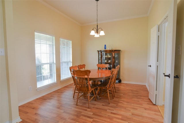 dining space featuring light wood-style flooring, baseboards, a chandelier, and crown molding