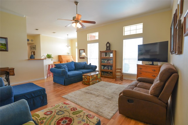 living area with light wood-style floors, crown molding, and baseboards