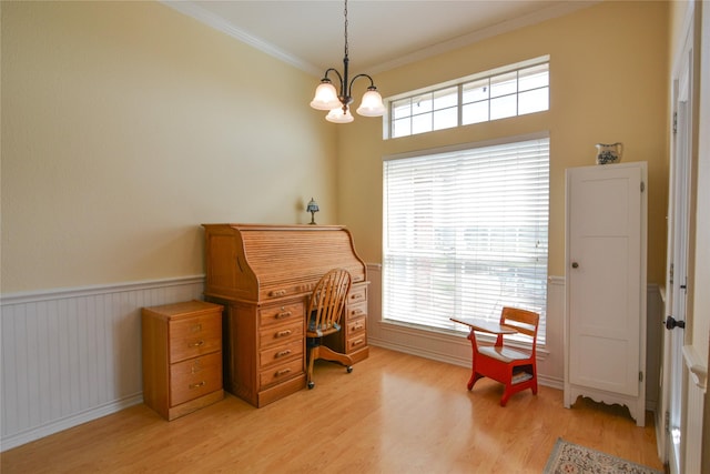 home office featuring light wood-type flooring, a wainscoted wall, a chandelier, and crown molding