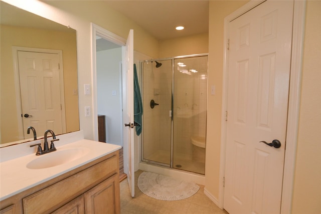 bathroom featuring a stall shower, tile patterned flooring, vanity, and recessed lighting