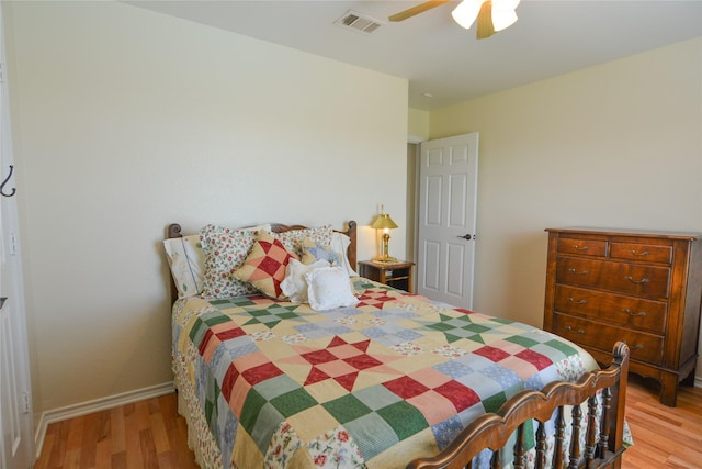 bedroom with visible vents, ceiling fan, baseboards, and wood finished floors