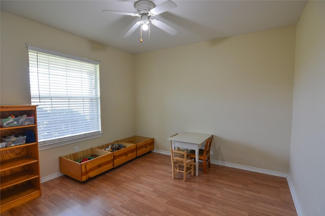 playroom featuring ceiling fan, baseboards, and wood finished floors