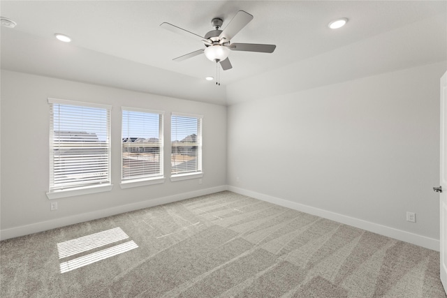 empty room featuring baseboards and light colored carpet