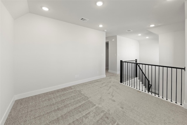 carpeted empty room featuring visible vents, baseboards, and recessed lighting