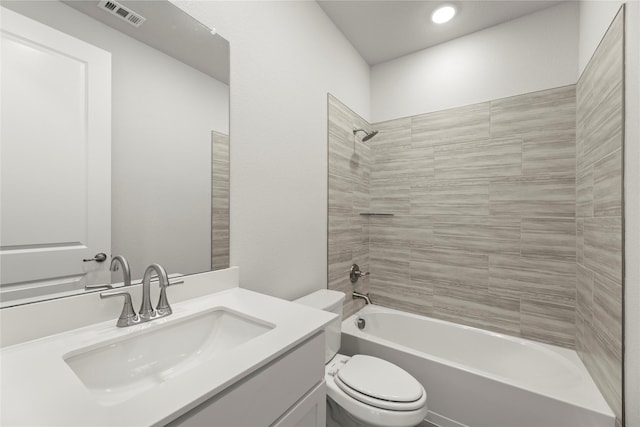 full bath with visible vents, vanity, toilet, and tub / shower combination