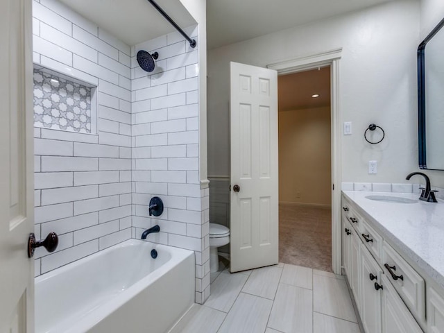 bathroom with washtub / shower combination, vanity, and toilet