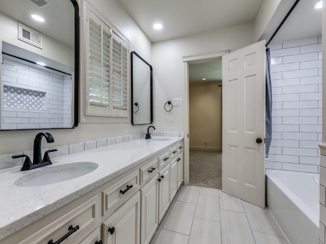 full bath with double vanity, shower / bath combination, a sink, and visible vents