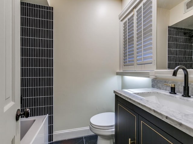 full bath with visible vents, vanity, toilet, and baseboards