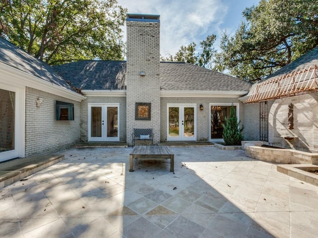 view of patio featuring an outdoor fireplace and french doors