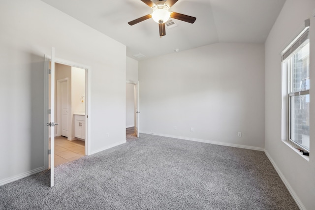 unfurnished bedroom with light carpet, multiple windows, lofted ceiling, and visible vents