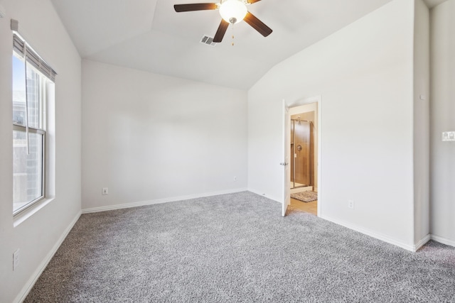 unfurnished room with vaulted ceiling, visible vents, plenty of natural light, and light carpet