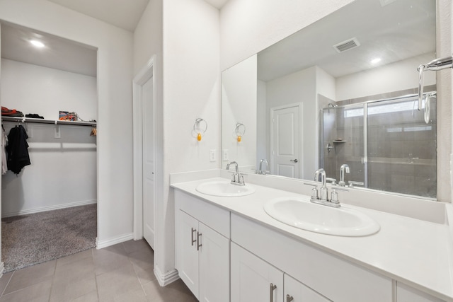 full bathroom with a shower stall, visible vents, a sink, and tile patterned floors