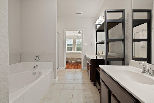 ensuite bathroom with a garden tub, visible vents, vanity, ensuite bath, and tile patterned floors