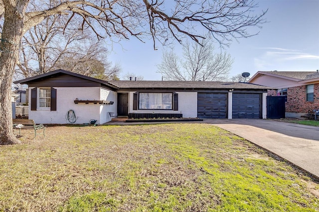 single story home with an attached garage, a front yard, concrete driveway, and brick siding