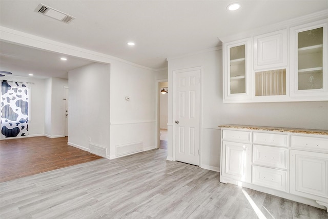 interior space featuring light wood-type flooring, visible vents, and recessed lighting