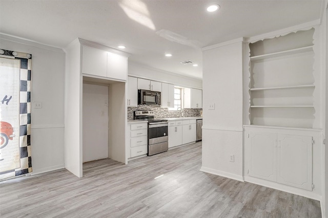 kitchen featuring light countertops, visible vents, light wood-style flooring, appliances with stainless steel finishes, and white cabinets