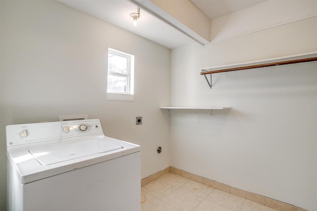 washroom featuring light tile patterned floors, laundry area, washer / dryer, and baseboards