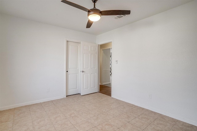 unfurnished room with visible vents, baseboards, and a ceiling fan