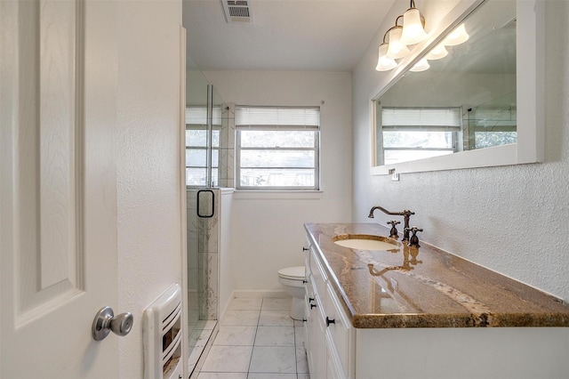 full bath with toilet, vanity, visible vents, heating unit, and a stall shower