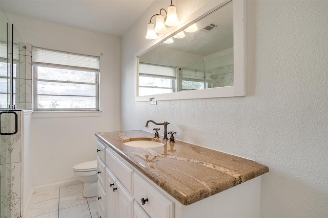 bathroom featuring toilet, vanity, baseboards, visible vents, and a shower stall