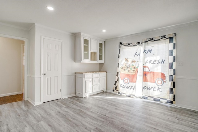 interior space featuring crown molding, recessed lighting, baseboards, and light wood-style floors