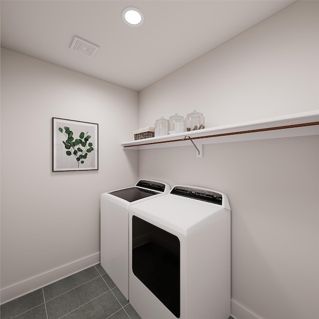 laundry room featuring washer and clothes dryer, visible vents, dark tile patterned flooring, laundry area, and baseboards