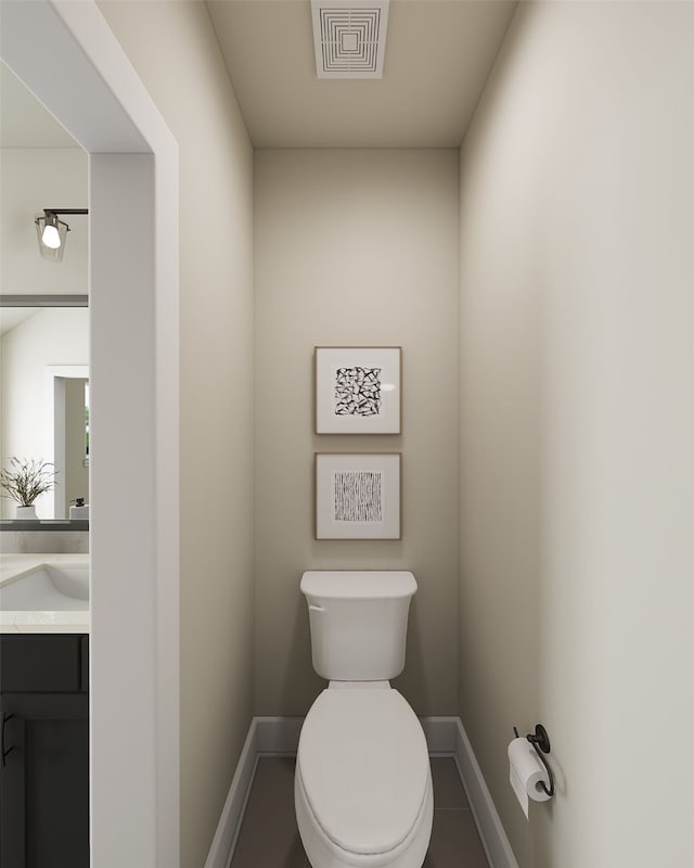 half bathroom featuring toilet, baseboards, visible vents, and vanity