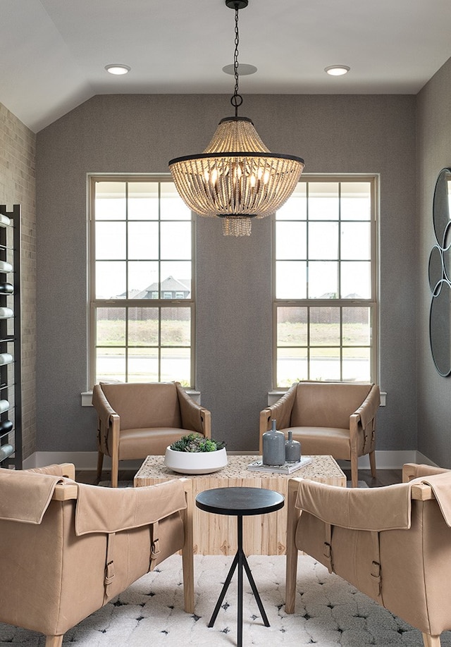 interior space featuring vaulted ceiling and a notable chandelier