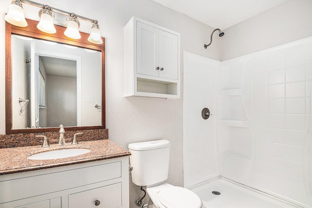 full bathroom featuring vanity, toilet, and walk in shower