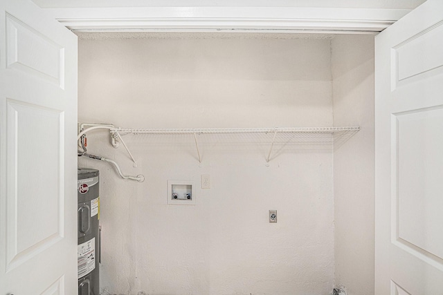 laundry room with hookup for a washing machine, water heater, and laundry area