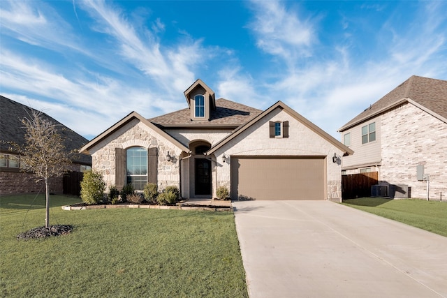 french country style house with a garage, stone siding, driveway, and a front lawn