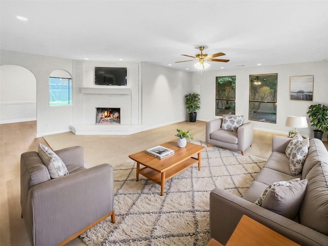 living area with recessed lighting, a fireplace, and baseboards