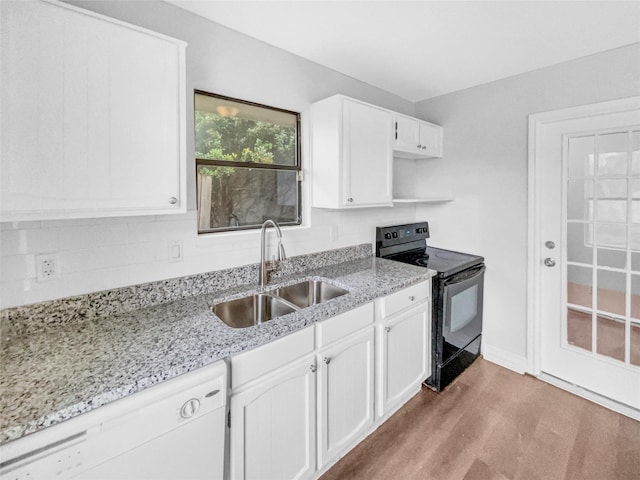 kitchen featuring dishwasher, black range with electric stovetop, light wood-style floors, white cabinetry, and a sink