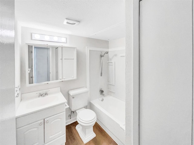 bathroom with shower / bath combination, toilet, wood finished floors, a textured ceiling, and vanity