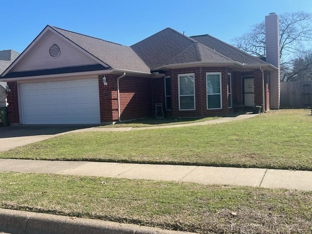 single story home featuring brick siding, a chimney, concrete driveway, an attached garage, and a front yard