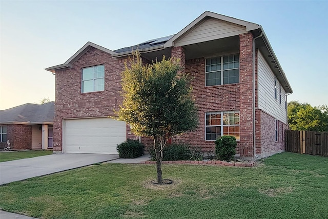 traditional home with a front yard, concrete driveway, and brick siding