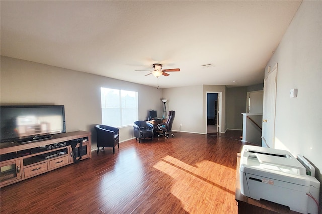 home office featuring ceiling fan, visible vents, baseboards, and dark wood-style flooring