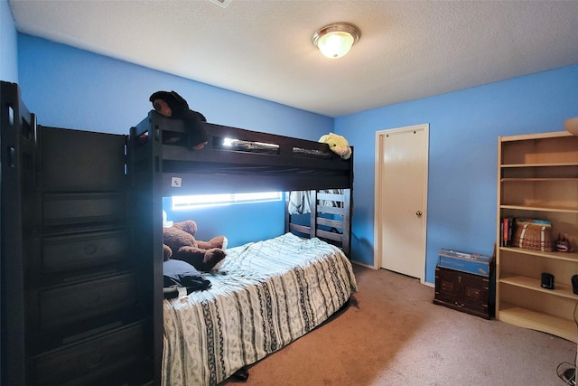 carpeted bedroom with a textured ceiling