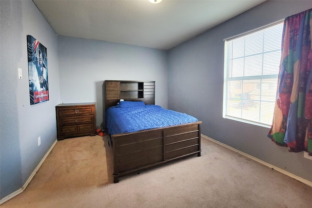 carpeted bedroom with baseboards