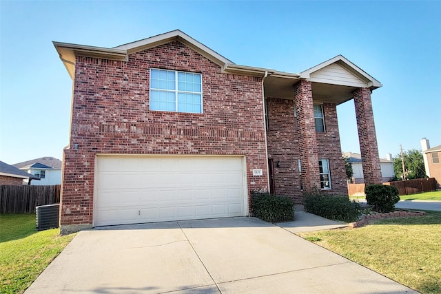 traditional-style house with brick siding, concrete driveway, an attached garage, fence, and a front lawn