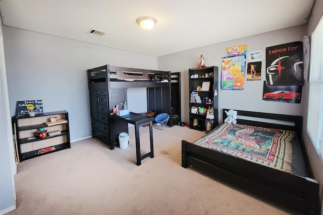 carpeted bedroom featuring visible vents