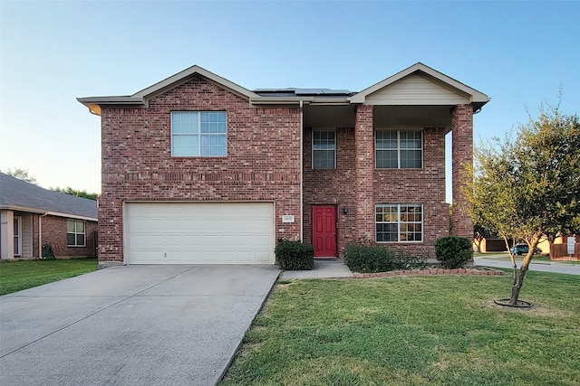 traditional-style house featuring driveway, brick siding, and a front yard