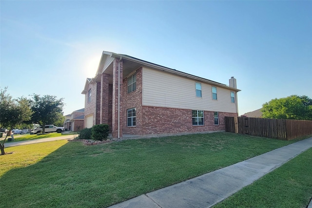 view of side of home with brick siding, a chimney, a lawn, an attached garage, and fence