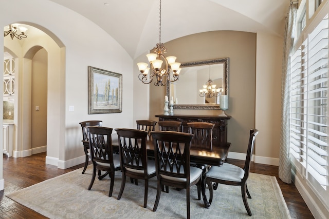 dining area with lofted ceiling, dark wood-style floors, baseboards, and a notable chandelier