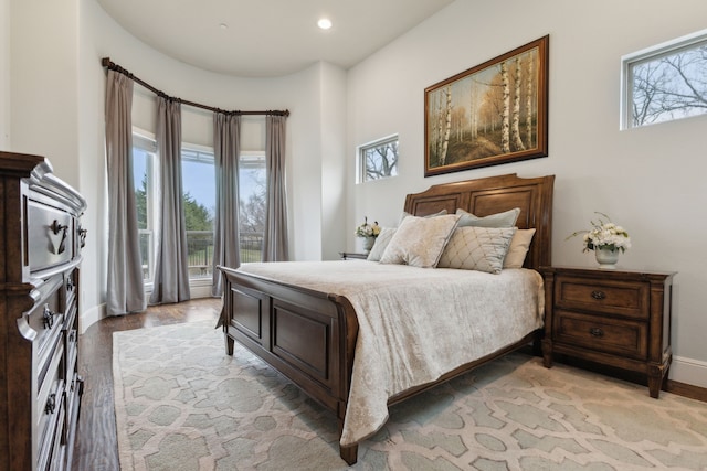 bedroom with light wood-style floors, recessed lighting, and baseboards