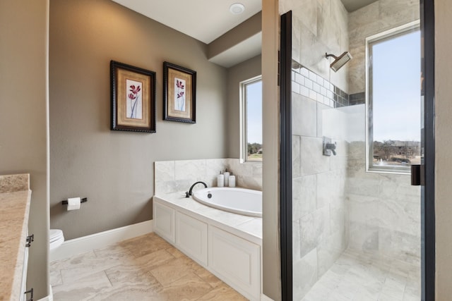 bathroom featuring a stall shower, baseboards, toilet, marble finish floor, and a bath